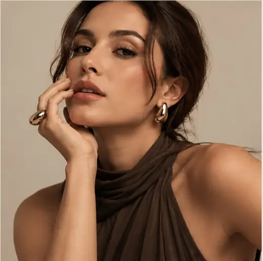 Editorial ATTO com modelo usando brincos e anel dourados